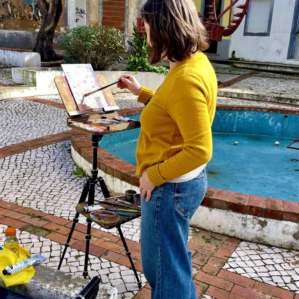 An artist painting outdoors in Faro.